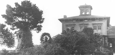 Muir House with a tent pitched over front porch.